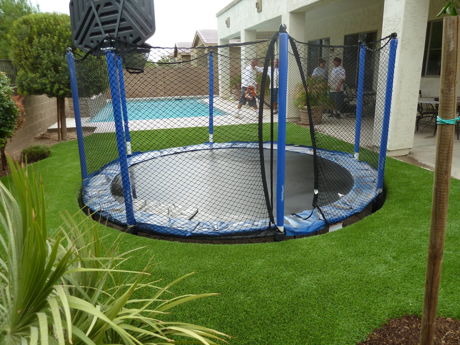 In-ground trampoline set in artificial turf, installed by Arizona Turf Masters