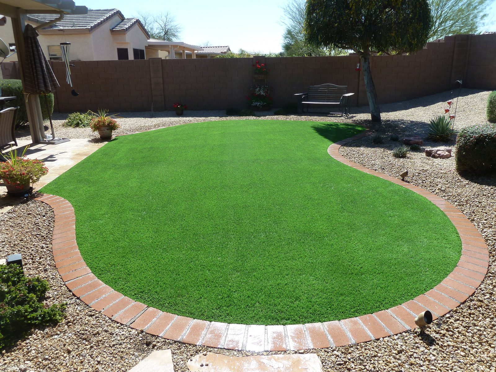 Turf lawn with a brick border, installed by Arizona Turf Masters