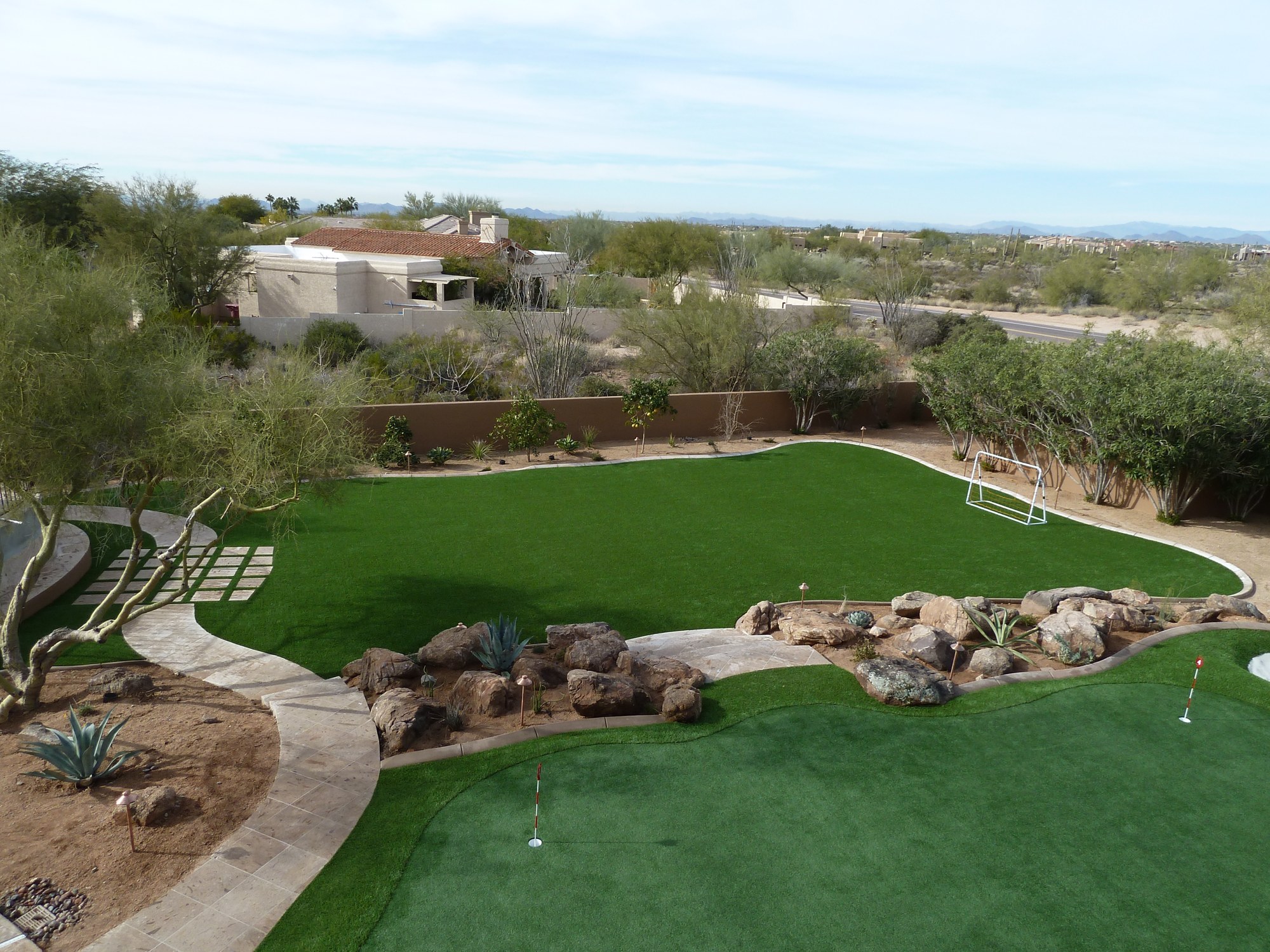 Finished artificial turf backyard lawn and putting green at an Arizona desert home
